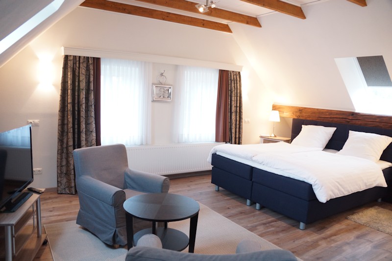 Schlafzimmer mit Boxspringbett und Sitzecke